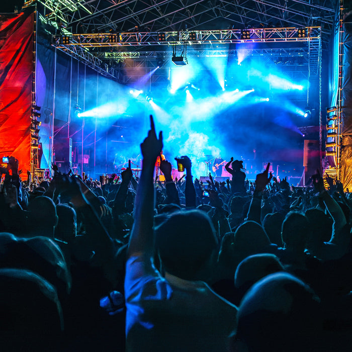 Outdoor stage lit up at night to demonstrate the importance of portable power for concert venues.